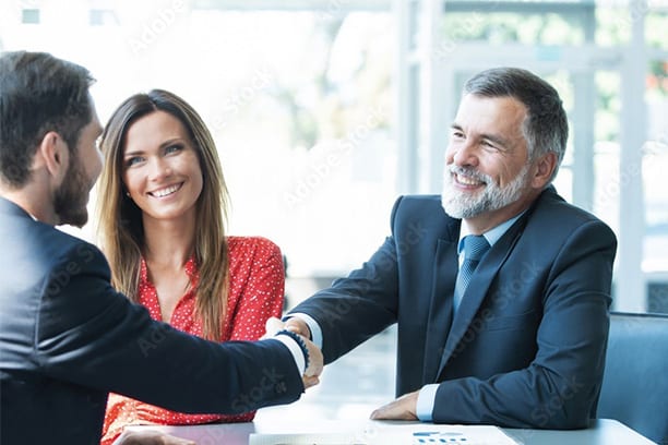 Photo of business men and women shaking hands