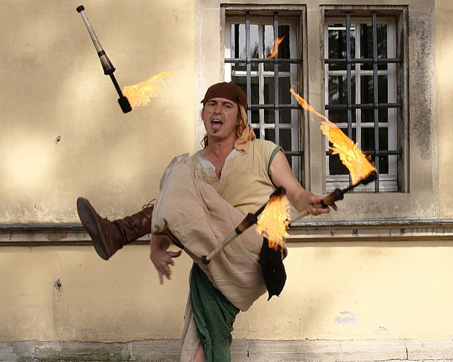 man juggling fire torches